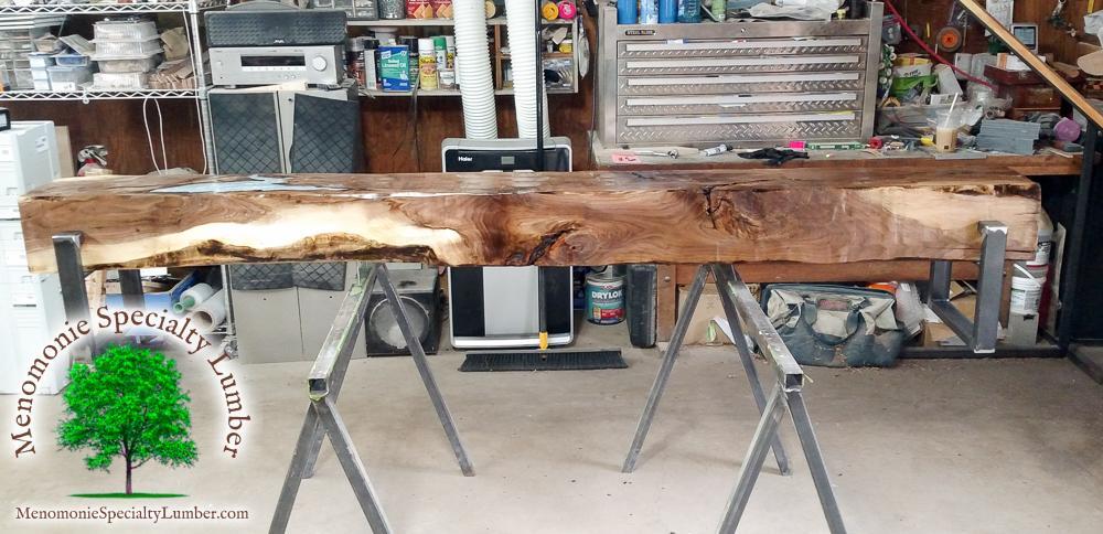 Black Walnut Rustic Bench with Molten Zinc Pour 8' long 12" square with custom welded steel legs.